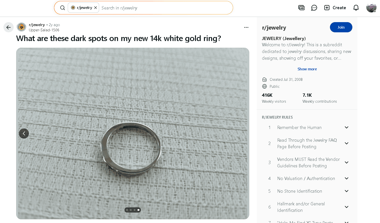 Rhodium coated 14k white gold vermeil ring with visible damage to its plating.